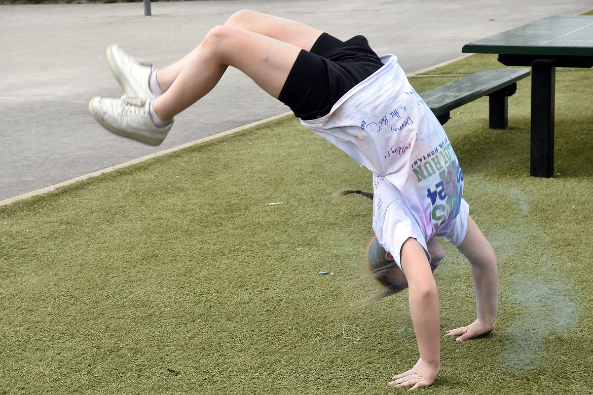 "Watch this! Should I do it again?" Deana Shestak cartwheels, sending puffs of color through the air (Kelsey Evans/Pilot).