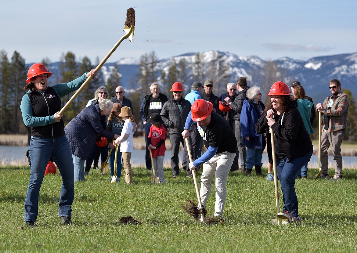 Deidre Corson, executive director of the North Valley Music School throws a shovel of soil at the groundbreaking ceremony April 19, 2024. (Julie Engler/Whitefish Pilot)