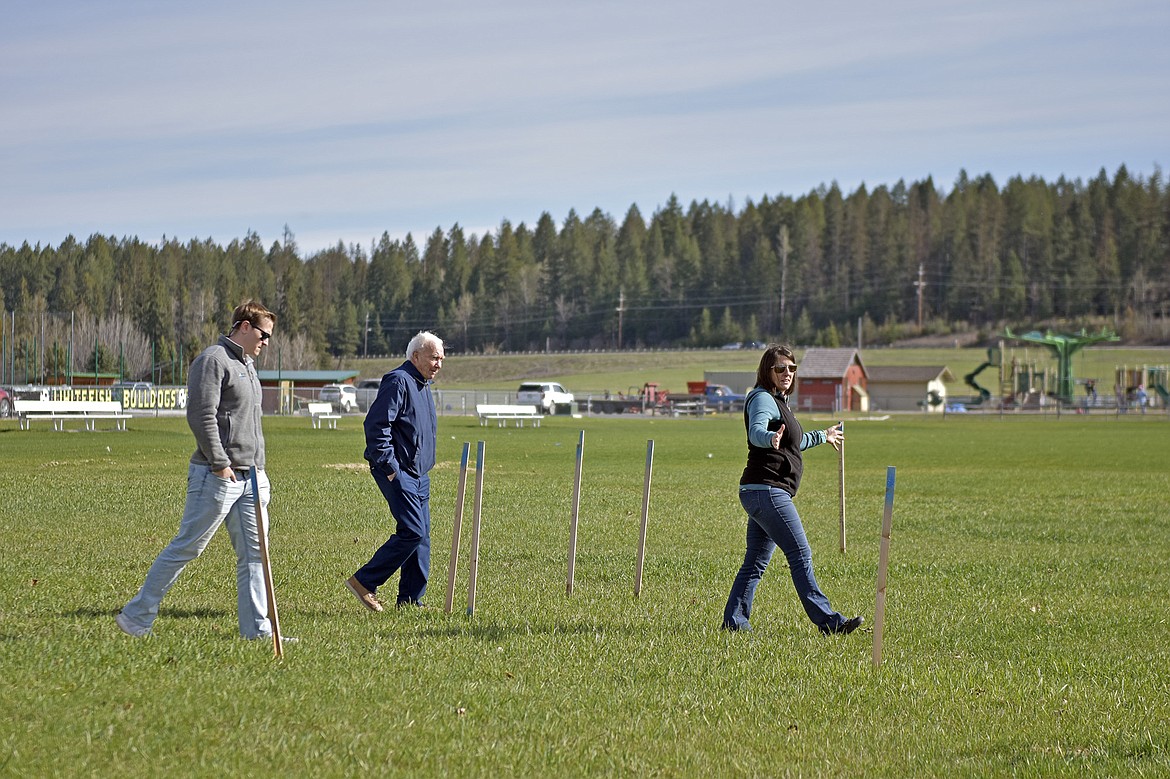 Deidre Corson, executive director of the North Valley Music School, walks through the staked area that will become the new school. (Julie Engler/Whitefish Pilot)