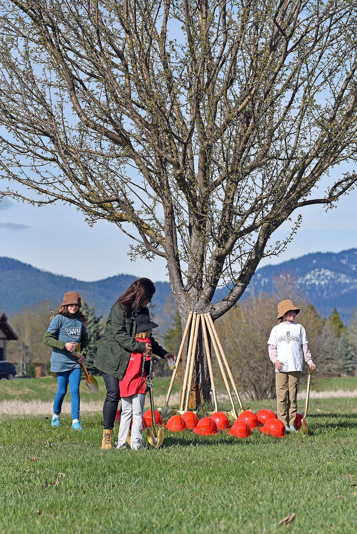 Visitors, shovels and hard hats await the groundbreaking for the North Valley Music School. (Julie Engler/Whitefish Pilot)