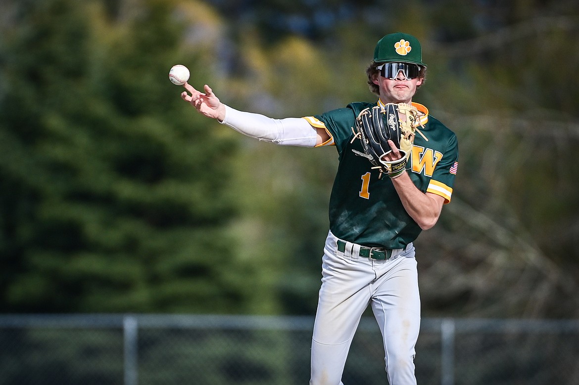 Whitefish shorstop Ryan Conklin (1) throws to first for an out against Bigfork at ABS Park in Evergreen on Tuesday, April 23. (Casey Kreider/Daily Inter Lake)