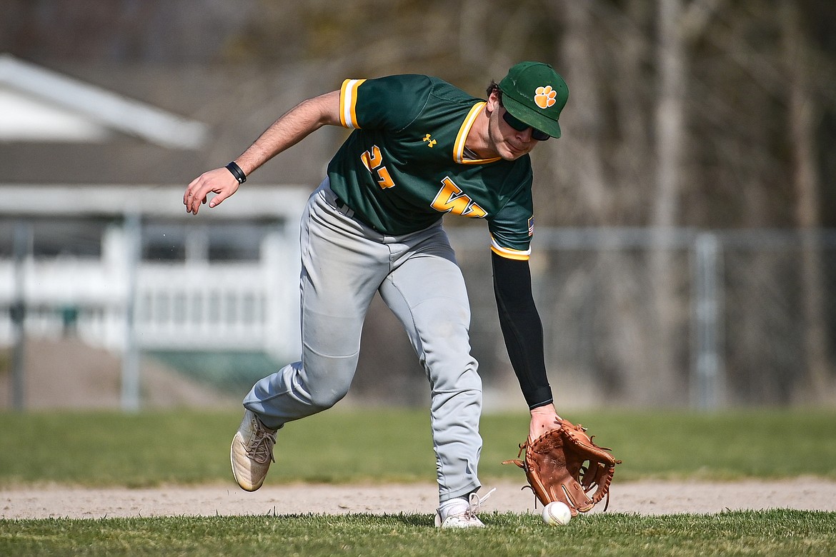 Whitefish third baseman Michael Miller (27) charges a grounder against Bigfork at ABS Park in Evergreen on Tuesday, April 23. (Casey Kreider/Daily Inter Lake)