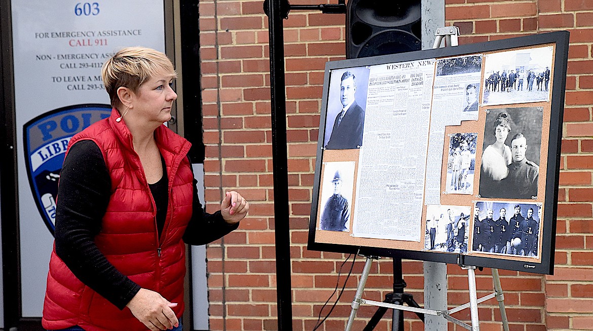 Dee Teske sizes up a display of old The Western News stories and photographs of former Libby Chief of Police John Ferdinand Bockman at an April 28, 2024, ceremony at the Libby Police Department. Bockman died in the line of duty on April 28, 1924, in Libby at the Great Northern Railway yard. (Scott Shindledecker/The Western News)