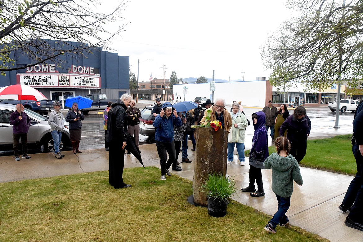 Attendees observe a memorial plaque in the name of former Libby Chief of Police John Ferdinand Bockman at an April 28, 2024, ceremony at the Libby Police Department. Bockman died in the line of duty on April 28, 1924, in Libby at the Great Northern Railway yard. (Scott Shindledecker/The Western News)