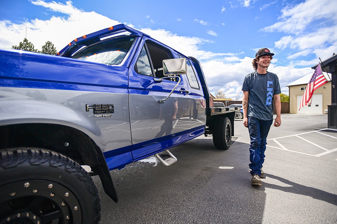 Tanner Lair smiles as he looks over his refurbished Ford F-250 from Glacier Collision Worx in Evergreen on Tuesday, April 30. The Make-A-Wish foundation provided $10,000 in funding to revamp the truck for Lair, who is in remission from non-Hodgkin lymphoma. (Casey Kreider/Daily Inter Lake)