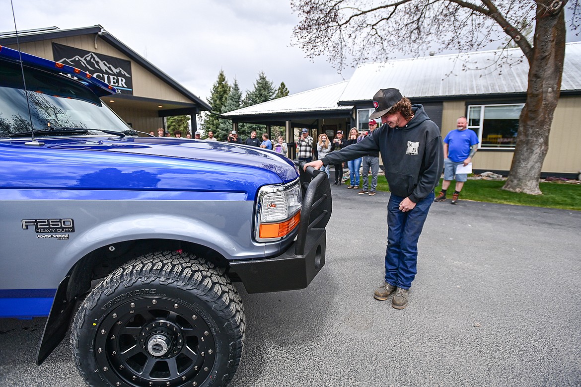 Tanner Lair smiles as he looks over his refurbished Ford F-250 from Glacier Collision Worx in Evergreen on Tuesday, April 30. The Make-A-Wish foundation provided $10,000 in funding to revamp the truck for Lair, who is in remission from non-Hodgkin lymphoma. (Casey Kreider/Daily Inter Lake)