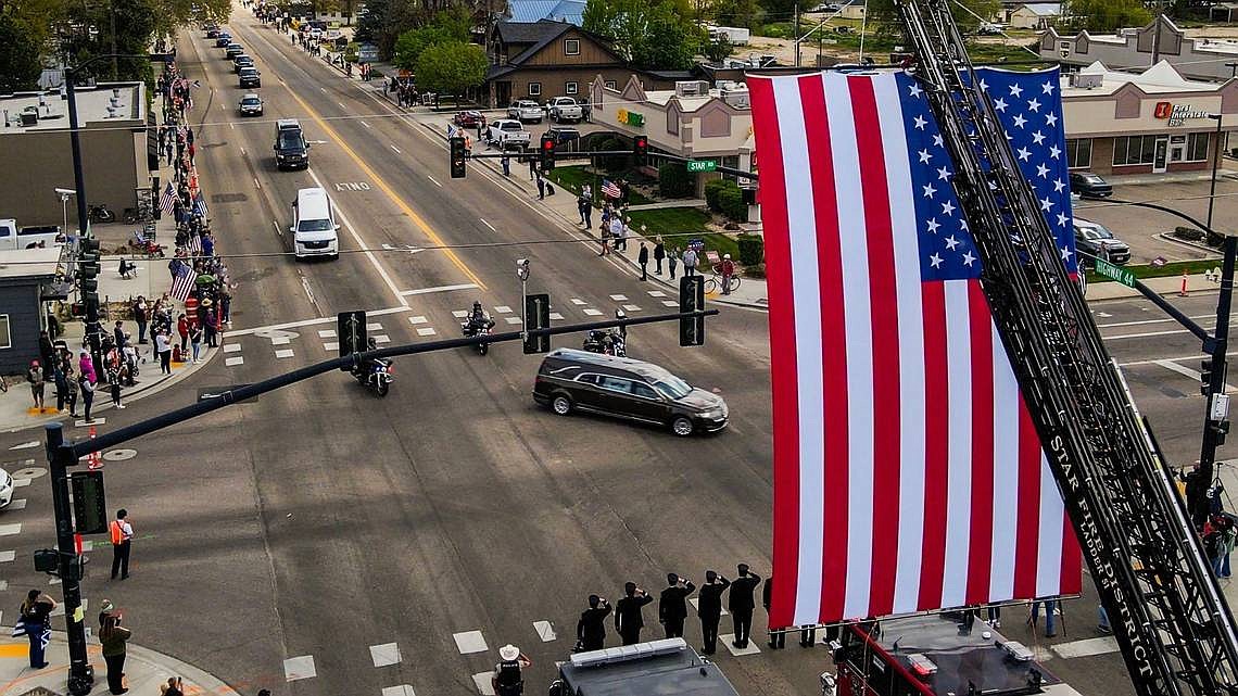 A two-hour long procession of law enforcement vehicles escorts the late Tobin Bolter, an Ada County Sheriff’s Deputy who was killed in the line of duty, on the way to a funeral held at the Ford Idaho Center. The procession began in Eagle, and found the streets of Star lined with people waving flags, including the Star Fire Department saluting the hearse with a giant U.S. flag flying from a ladder truck.