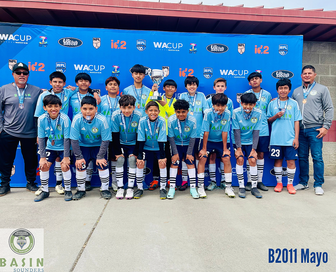 The B2011 Mayo Basin Sounders teams poses for a photo. Top row, left to right: Assistant Coach Enrique Villafana, Elmer Gonzalez, Hector Soriano, Vladymir Aquino, Deyvin Tolentino, Sebastian Nieto, Andy Mora, Anson Carlson, Roberto Aquino, Jason Godinez, Head Coach Edgar Mayo. Bottom row, left to right: Fernando Cardona, Joan Perez, Jose Garcia, Ej Mayo, Yeraldo De Jesus, Jesus Mejia, Christian Cardona. 
Not pictured: Graham Webb and Brandon Machado.