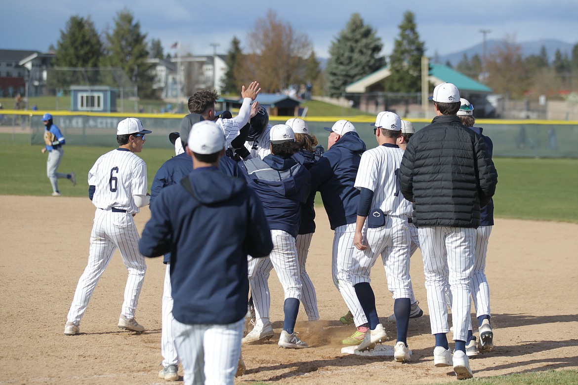 MARK NELKE/Press
Somewhere among his teammates, Avrey Cherry of Lake City is congratulated after his walk-off base hit in the eighth inning of the first game Tuesday vs. visiting Coeur d'Alene.