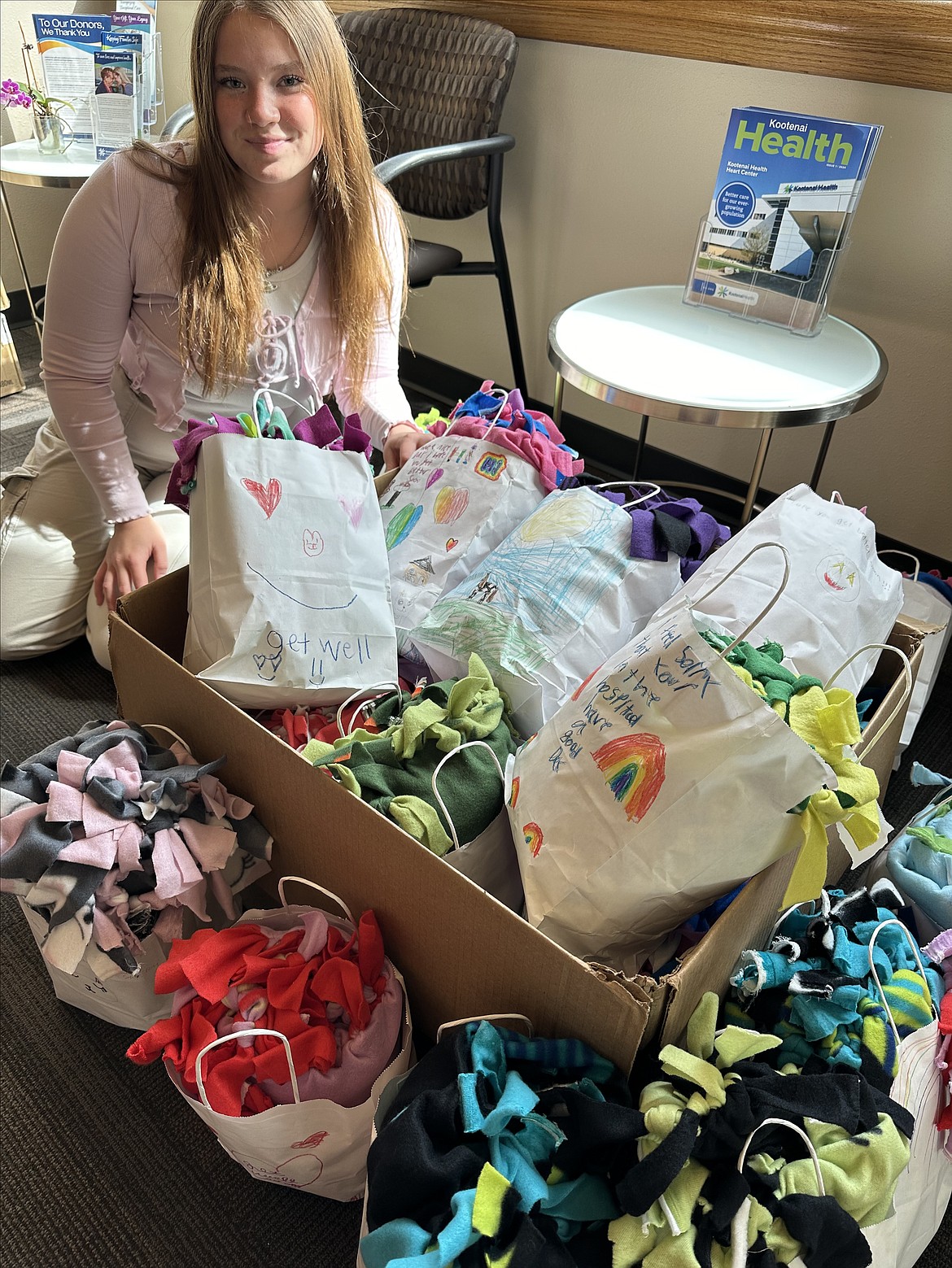 Adeline Smith, co-founder of the Growing the STEM nonprofit, is seen with colored bags filled with fleece tie blankets students donated to kids at Kootenai Health for Global Youth Service Day.