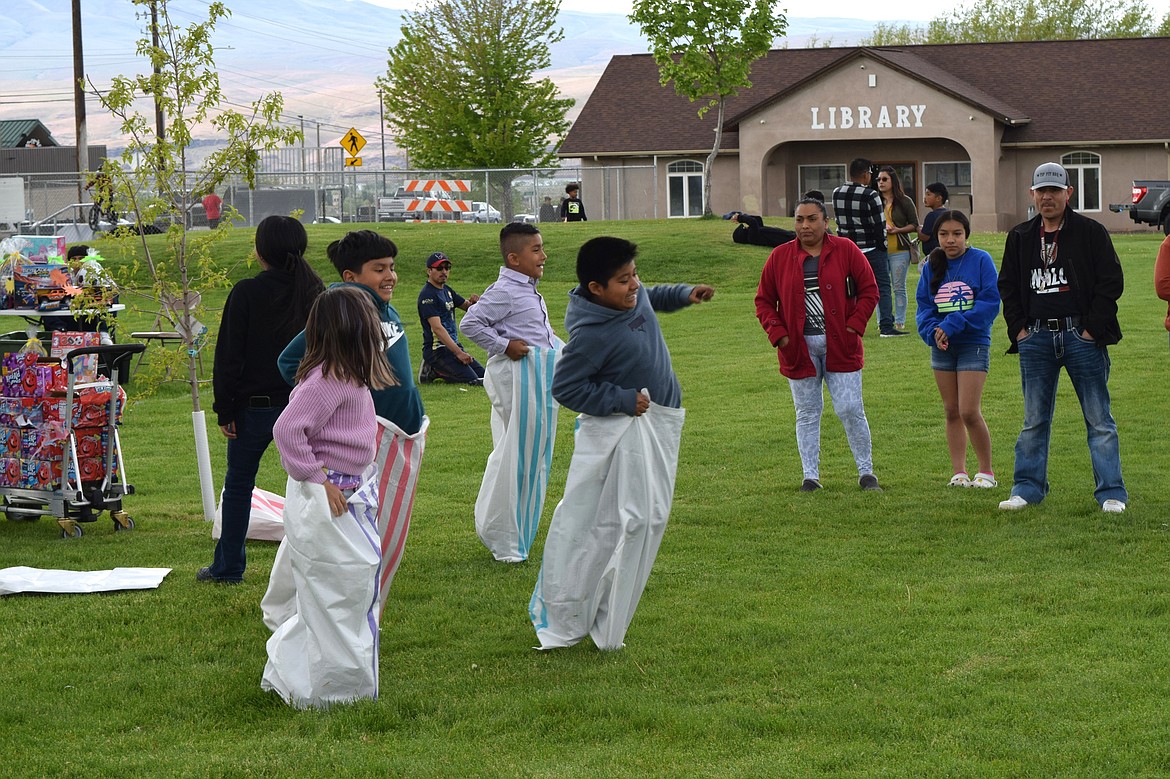 Children participate in a sack race in Hund Memorial Park during Saturday’s Children’s Day celebration.