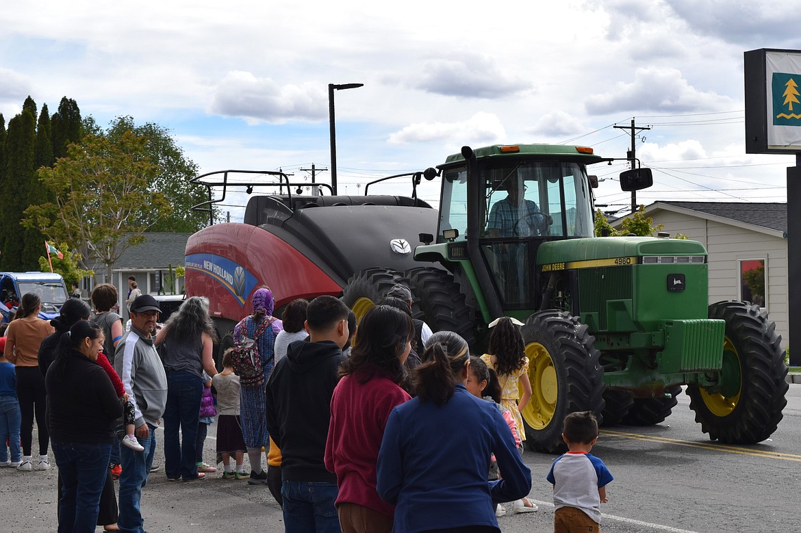 Wahluke School District Board Member Craig Sabin drives a tractor down Government Road for the Mattawa Children’s Day parade Saturday.