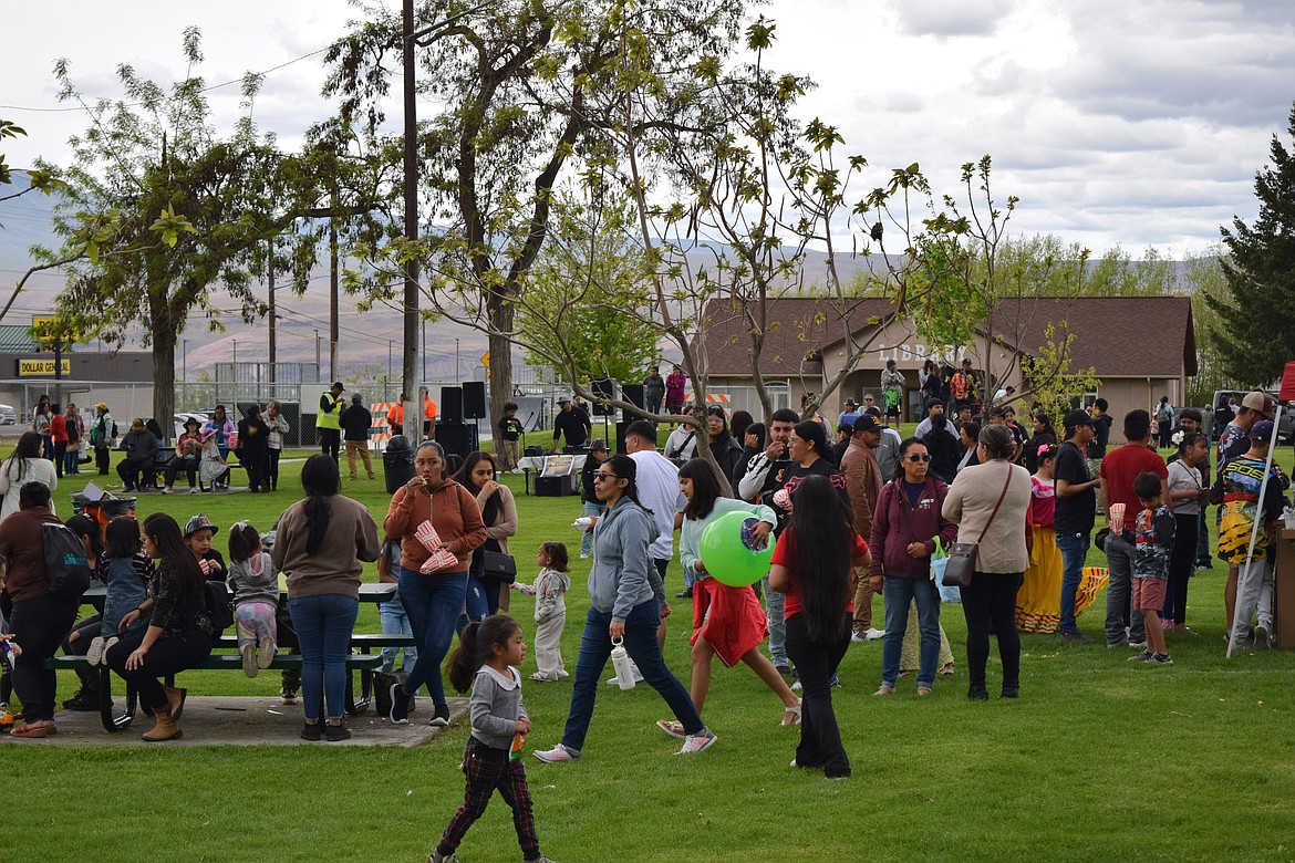 Event attendees line up for food and vendors at Hund Memorial Park during the Children’s Day celebration, which also included activities at the Mattawa Public Library, pictured behind the row of trees on the west edge of the park.