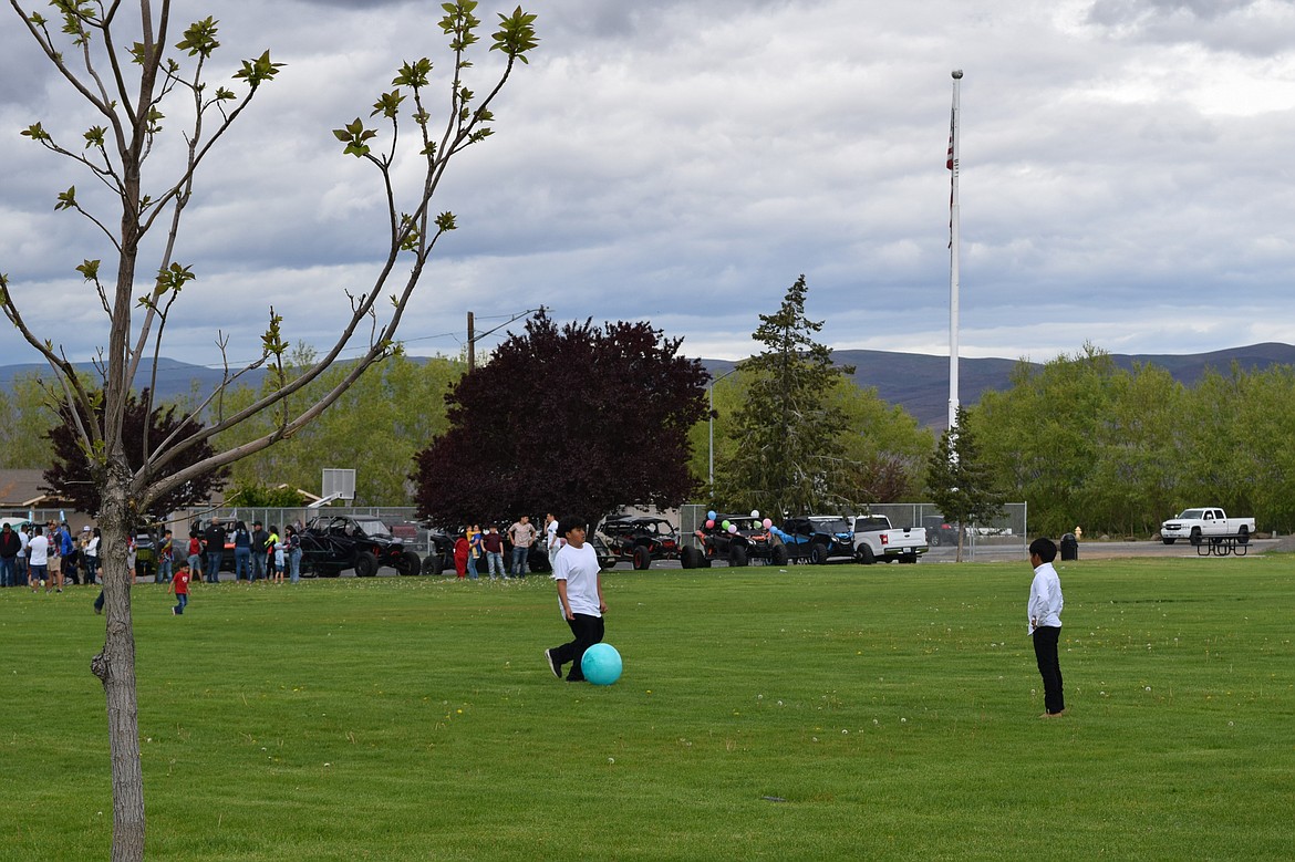 Children play with a rubber ball in Hund Memorial Park Saturday, surrounded by Children’s Day festivities.