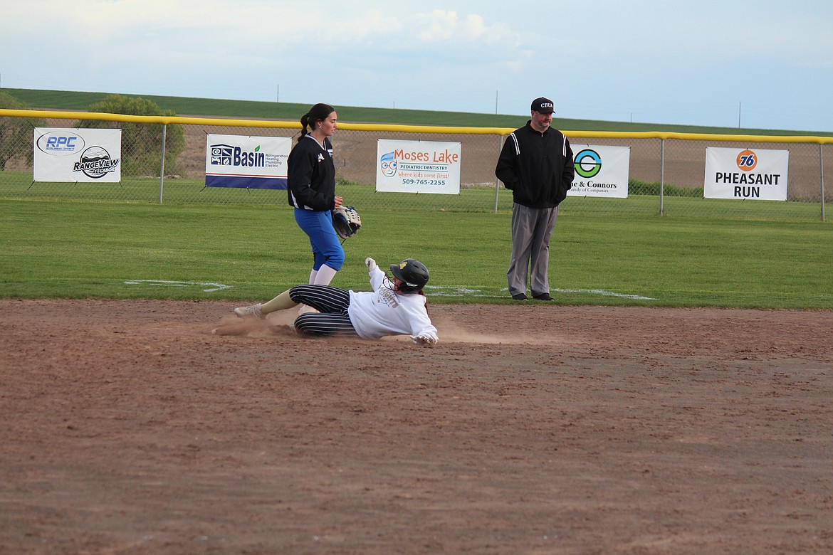 A Royal player slides into second during the Knights doubleheader with Warden.