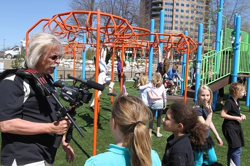 Councilman Woody McEvers interviews children at the McEuen Park opening.