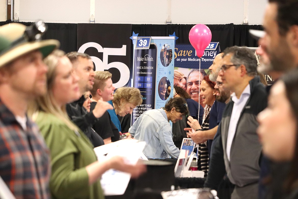 Visitors and business are face to face in conversation at the North Idaho Business Expo and Career Fair at the Kootenai County Fairgrounds on Wednesday.
