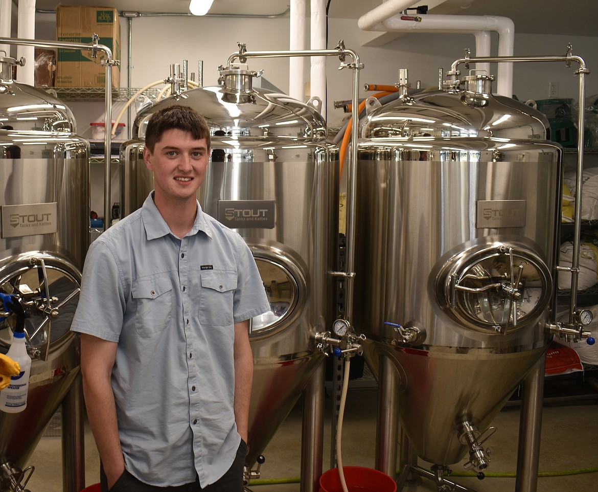 Moore Brewing Company Brewmaster Zach Moore stands in front of his fermentation tanks. The brewery’s works are visible from the bar, so patrons can watch their next batch of beer being made.