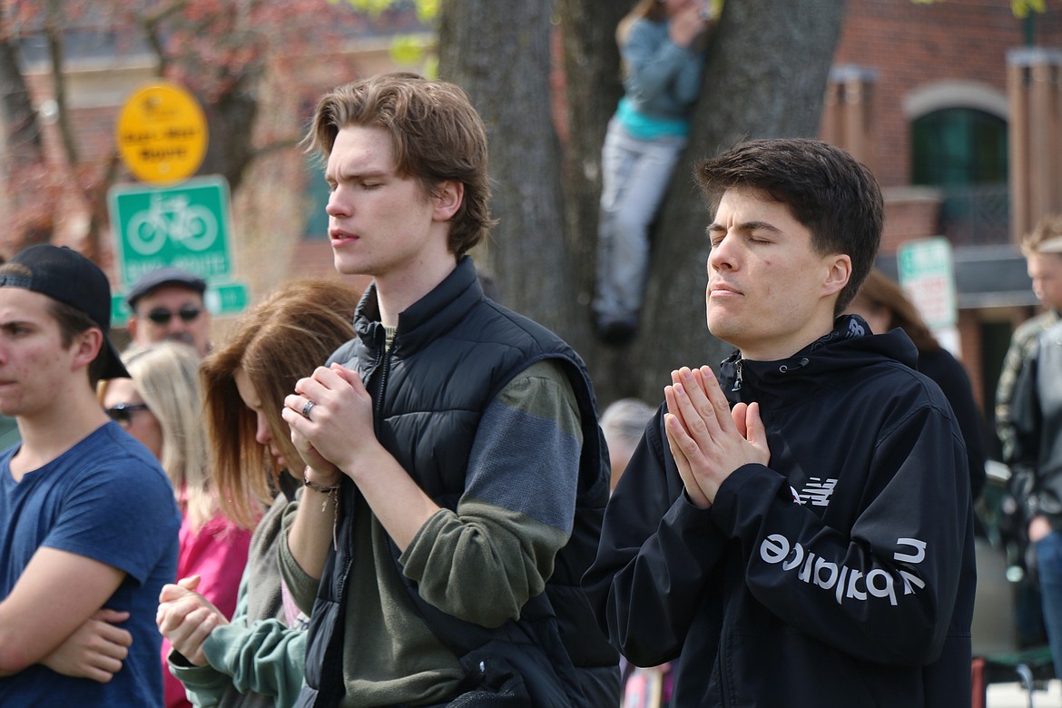 Area residents pray in Farmin Park as more than 100 people turned out for Thursday's National Day of Prayer event.