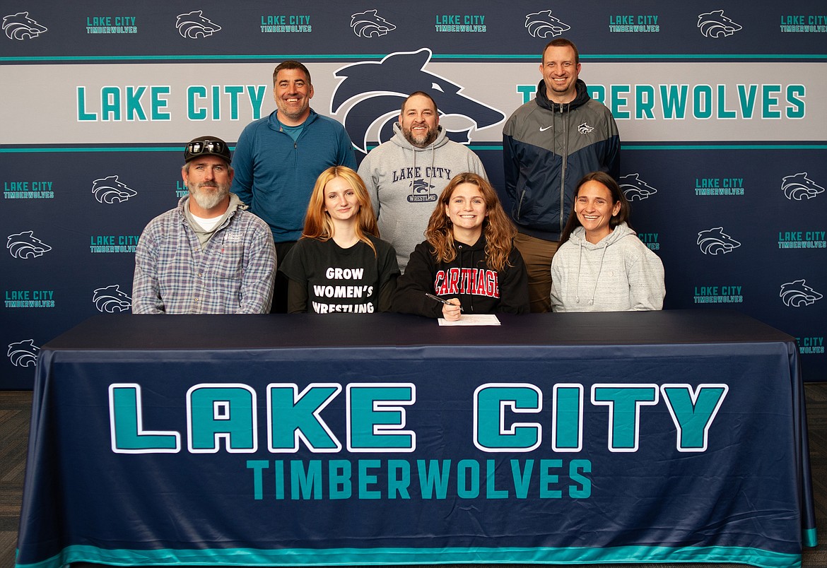 Courtesy photo
Lake City High senior Madi Cook recently signed a letter of intent to wrestle at NCAA Division III Carthage College in Kenosha, Wis. Seated from left are Ben Cook (father), Izzy Cook (sister), Madi Cook and Shelby Cook (mother); and standing from left, Corey Owen, Lake City High head wrestling coach; Nate DeLeon, Lake City High assistant wrestling coach; and Troy Anderson, Lake City High athletic director.