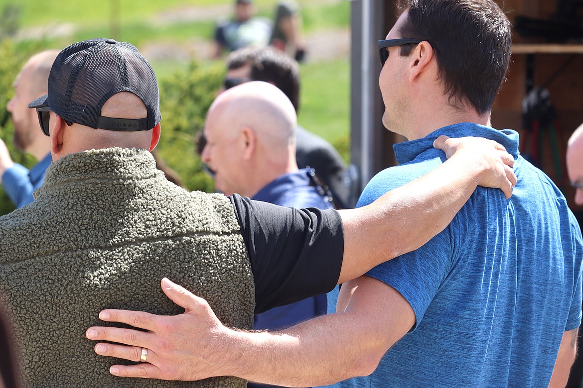 Pastors Jonathan Owens and Steve Hemming share a moment together at the National Day of Prayer in Coeur d'Alene on Thursday.