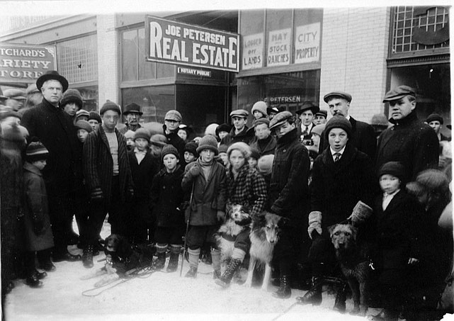 Sled Dog Race competitors, their dogs, and the race organizers. Tallest men, from left, attorney J.V. Hawkins, realtor Joe Petersen, and businessman Henry Glindeman.