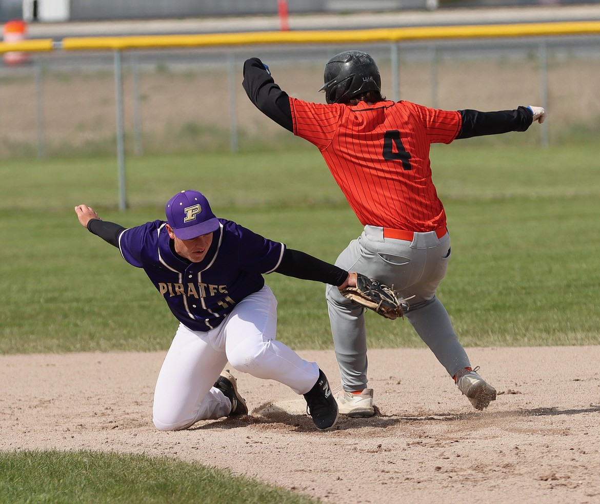 CLOSE CALL: Pirate Wyatt Wadsworth angles for an out against Chief Liam Wills during last Tuesday's game. (Niki Graham photo)