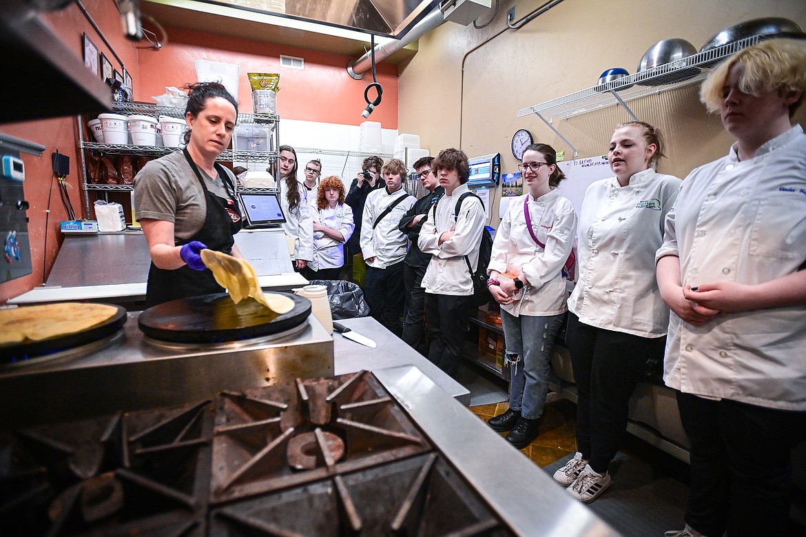 Sara Seed, owner of Amazing Crepes, demonstrates how to make a crepe to Glacier High School culinary students during the students' tour of Whitefish eateries and restaurants on Friday, May 3. (Casey Kreider/Daily Inter Lake)