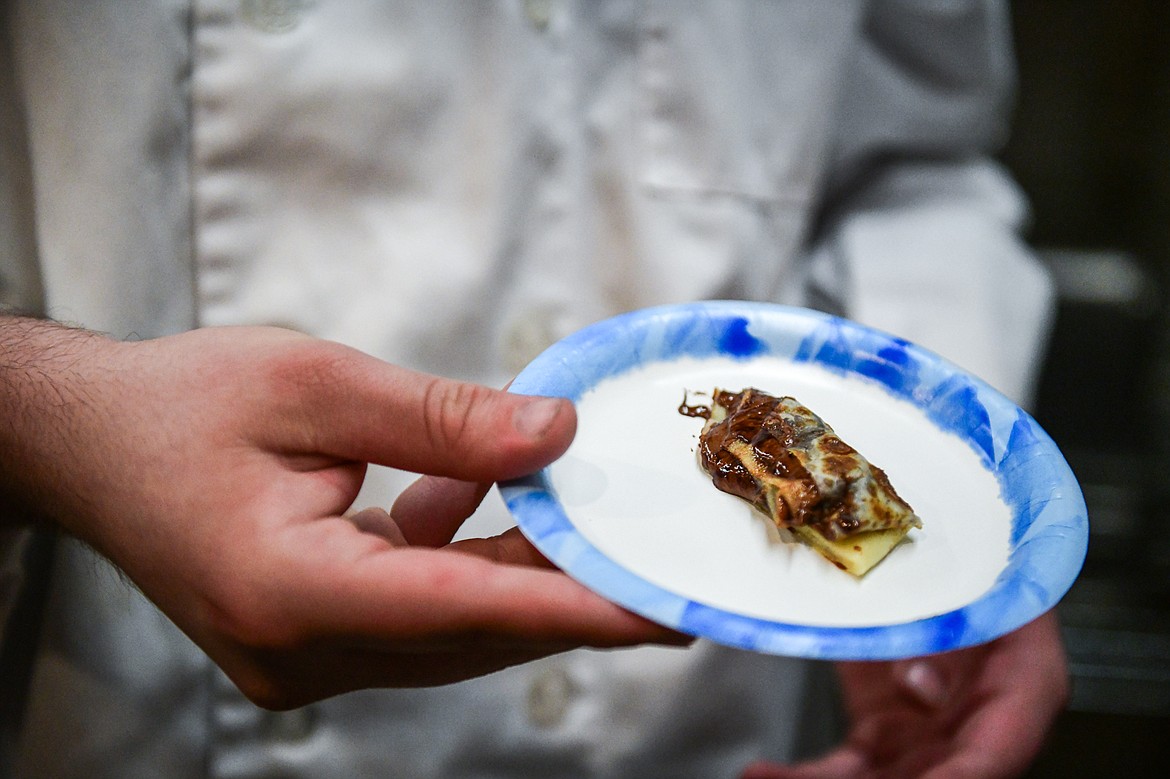 A student shows a bite-sized sample of a crepe made by Amazing Crepes owner Sara Seed during a demonstration as Glacier High School culinary students took a tour of several Whitefish eateries and restaurants on Friday, May 3. (Casey Kreider/Daily Inter Lake)