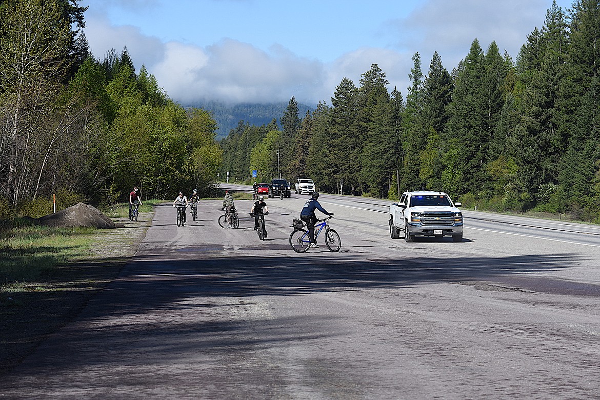 Participants of the Lincoln County Special Olympics Law Enforcement Torch Run took a quick break at a pullout on U.S. 2 near the Kootenai Falls before continuing to Libby. The event began at the Idaho state line before stopping in Troy. (Scott Shindledecker/The Western News)