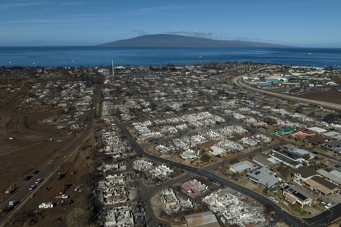 A general view shows the aftermath of a wildfire in Lahaina, Hawaii, Thursday, Aug. 17, 2023. Maui County is suing major cellular carriers for failing to properly inform police of widespread service outages during the height of last summer's deadly wildfire. (AP Photo/Jae C. Hong, File)