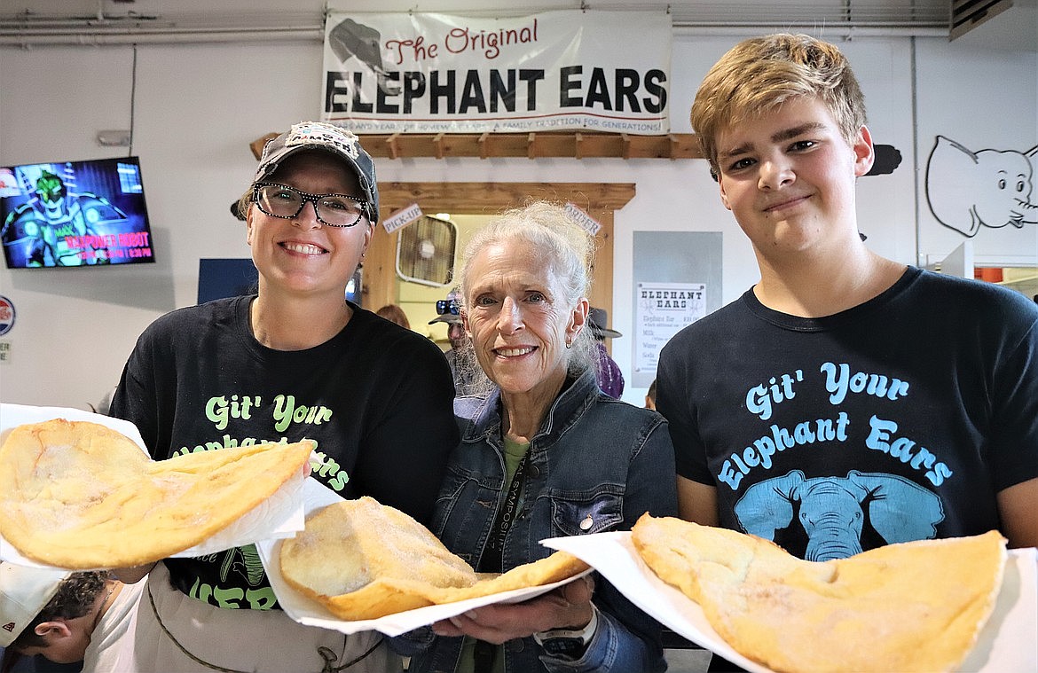 Three generations serve up elephant ears at the North Idaho State Fair in 2023. From left, Briettney, Sandra Davis and Max Davis.