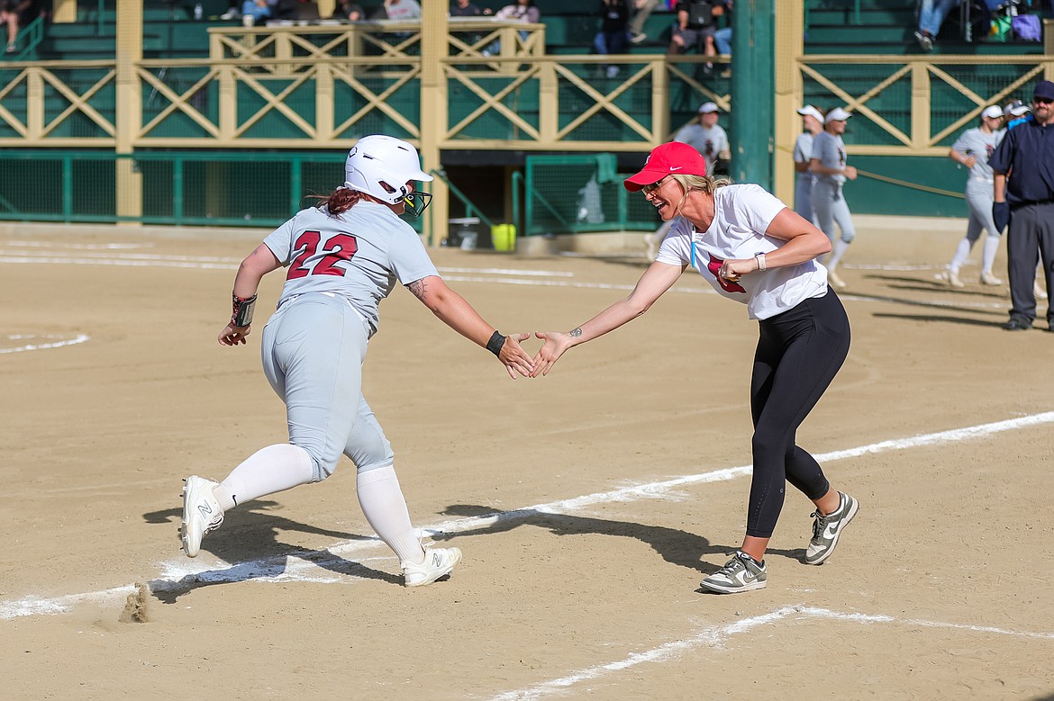 KYLE DISHAW PHOTOGRAPHY
North Idaho College softball coach Shay Chapman greets Summer Makinster after rounding third base following Makinster's two-run home run in the second game of a Northwest Athletic Conference doubleheader against Memorial Field on Friday.