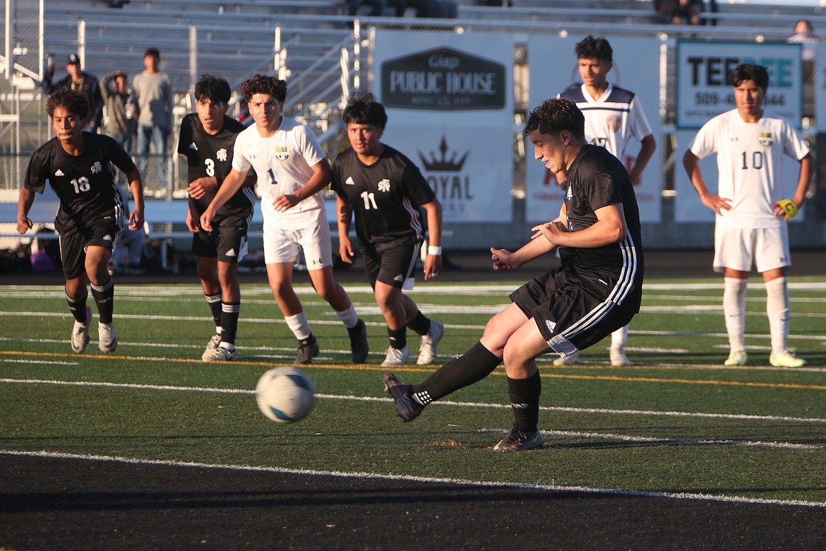 Royal senior Santiago Gonzalez, foreground, shoots the ball during a penalty kick in the 58th minute against Wapato. Gonzalez scored both of Royal’s goals in the 2-0 win.