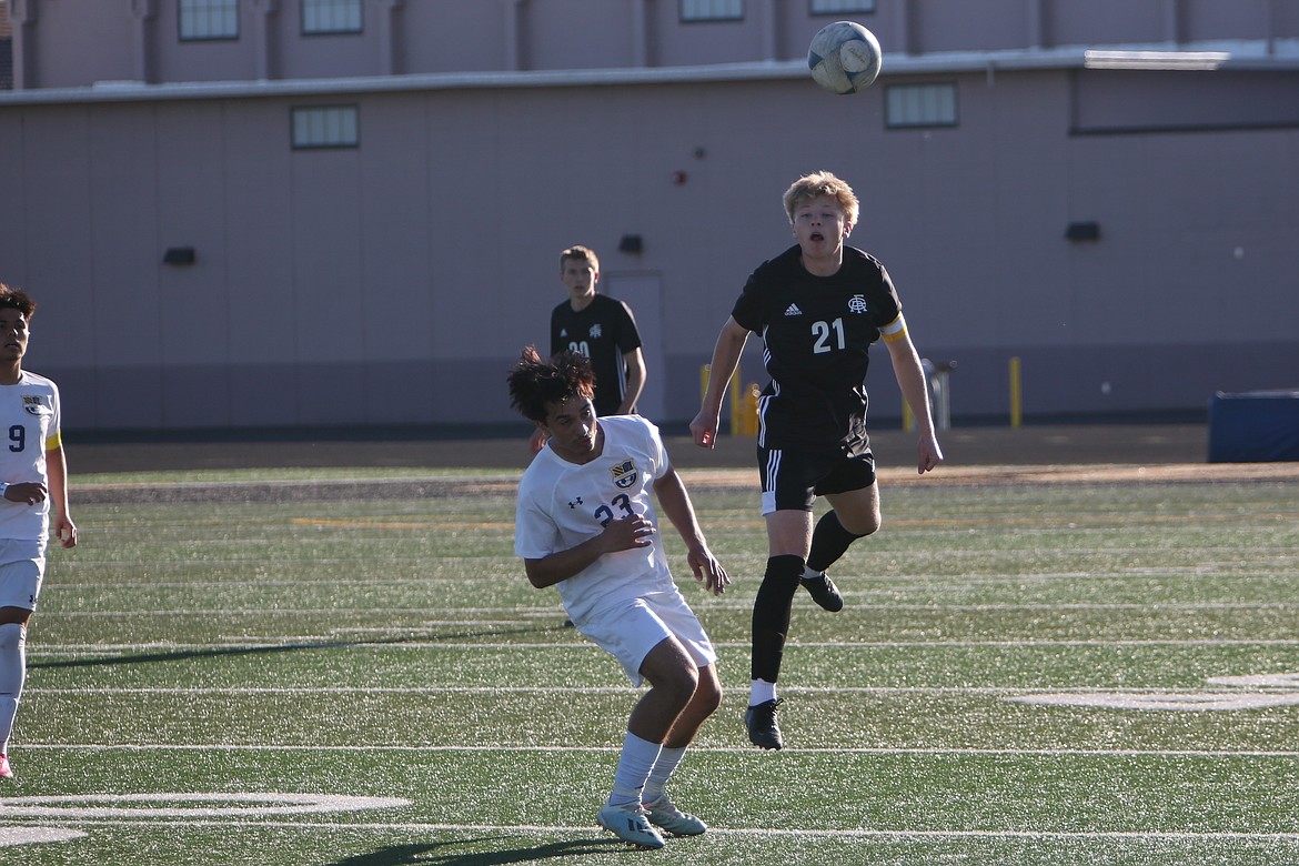 Royal senior Case Christensen (21) heads the ball back toward a Knight teammate in the first half of Thursday’s SCAC district tournament game against Wapato.