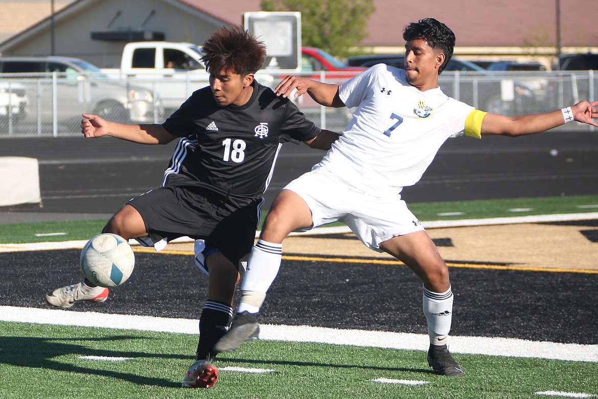 Royal sophomore Victor Aquino (18) receives a pass from a teammate in the first half against Wapato on Thursday.