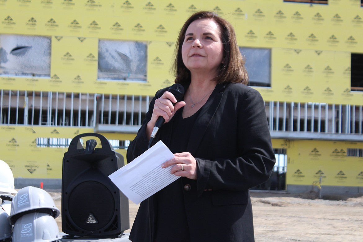 Samaritan Chief Executive Officer Theresa Sullivan talks about the hospital project before the last piece was added to the steel framing Friday.