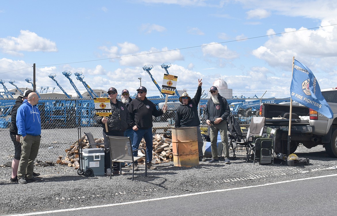 Boeing firefighters picket outside the company’s Moses Lake facility after being locked out Saturday.