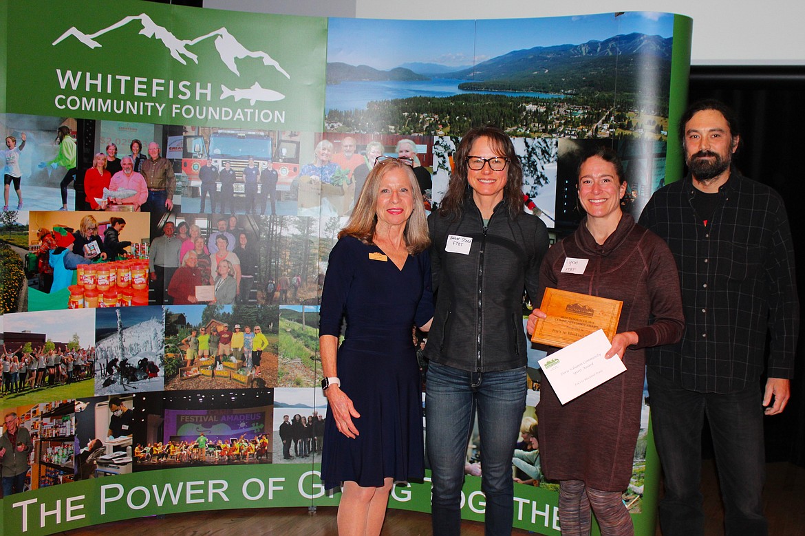 Whitefish Community Foundation board member Lucy Smith, left, presents the Doris Schumm Community Spirit Award to Foy’s to Blacktail Trails. (Courtesy photo)