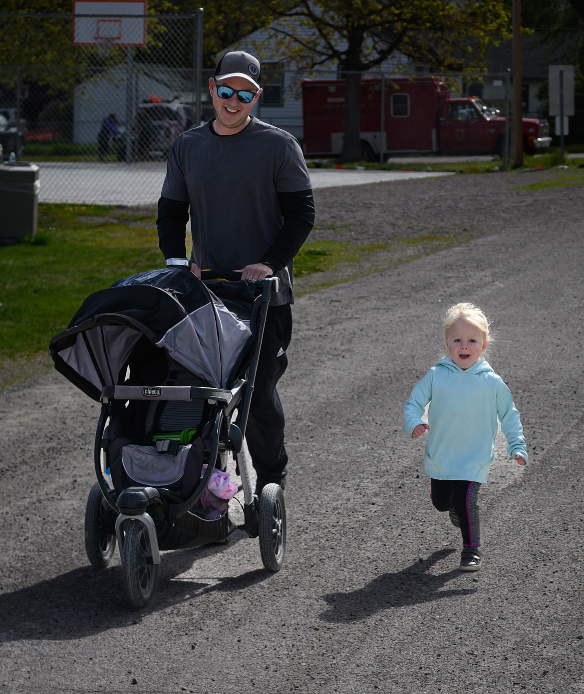 Bison Stampede runners Rebecca Baumann, 2, and dad Jake Near at the finish of the 5K race. (Tracy Scott/Valley Press)