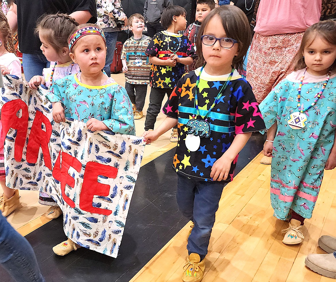 Arlee Head start children march in during the grand entry at the Head Start Powwow, looking for parents or relatives in the audience. (Berl Tiskus/Leader)