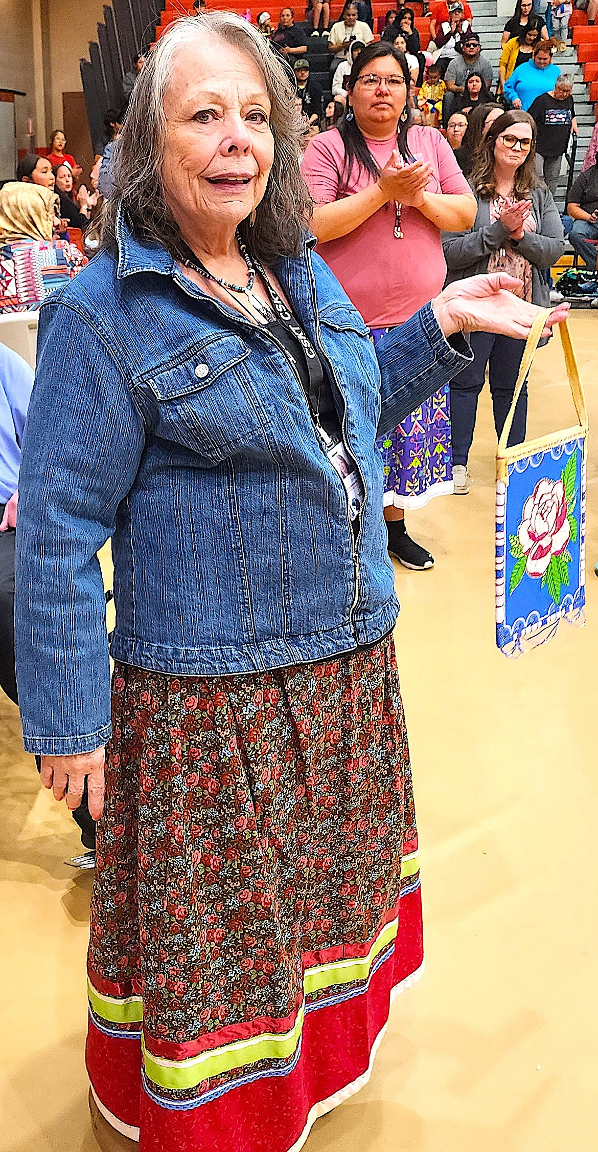 JJeanne Christopher, Head start director, is retiring. She is holding Her gift from the administrative staff -- a fully beaded buckskin bag made by Nicole Perry. (Berl Tiskus/Leader)