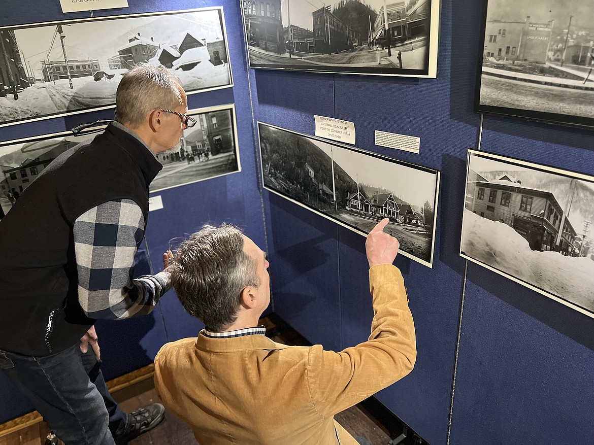 Carl Rowe (right) points out a historic detail as he and another guest peruse the new collection of panoramic photos at the Barnard-Stockbridge Museum's Spring Fling Gala.