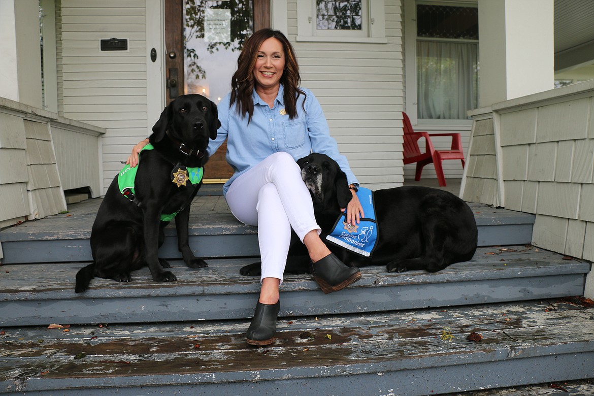 Kona, pictured left, and Ken, pictured right, pose for a photo on the steps of the LillyBrooke Family Justice Center with Peggy Sherbon, the director of the Bonner County Prosecutor's Investigations and Victim Service Division. The two facility dogs are used during victim’s interviews and court testimony, especially in cases involving youth.

Photo by CAROLINE LOBSINGER