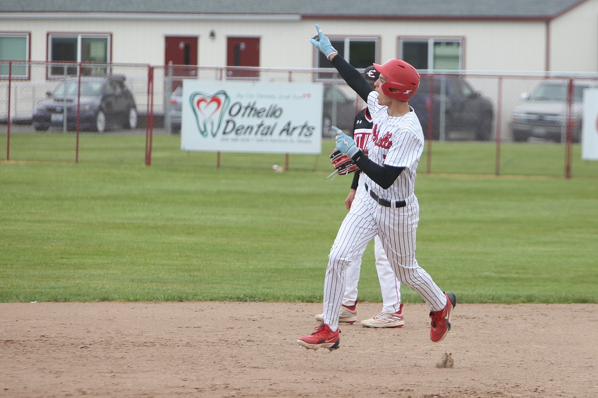 Othello sophomore RJay Garza, in white, trots past second base and celebrates after hitting a solo home run in the bottom of the fourth inning.