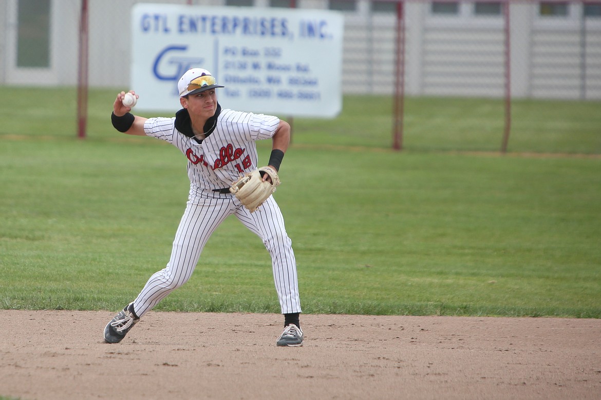 Othello sophomore Quade Gonzalez looks toward first base after picking up a ground ball against East Valley (Yakima) on Saturday.