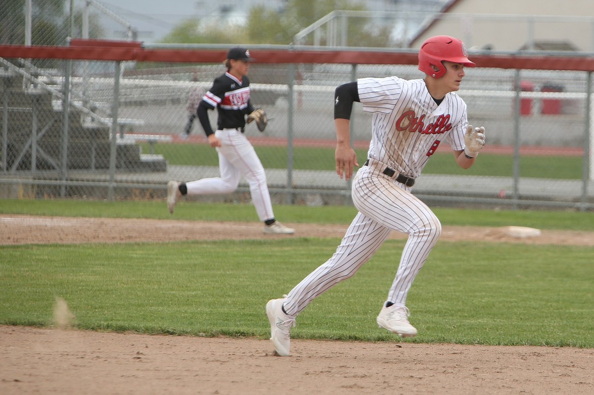 Othello junior Jordan Montemayor, in white, dashes toward third base against East Valley (Yakima) on Saturday.