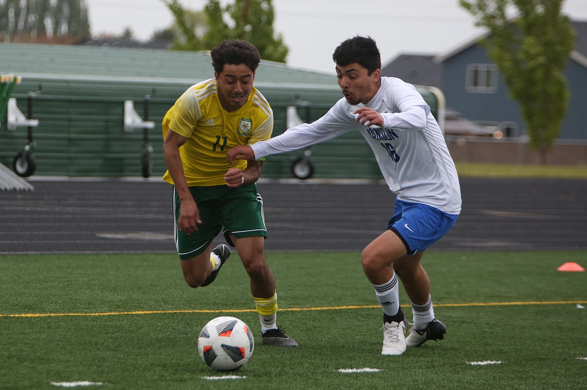 Quincy senior Alexander Murillo (11) pushes the ball into the penalty area in the second half against Manson on Saturday.