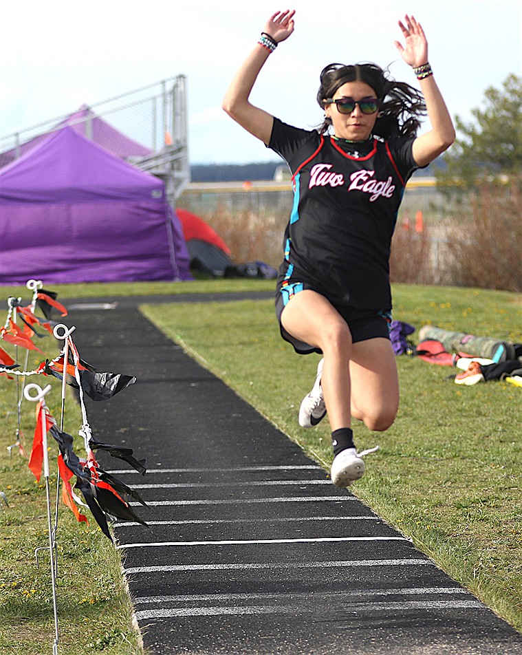 Two Eagle competitor takes flight in the long jump during last week's all-county meet in Ronan. (Bob Gunderson photo)