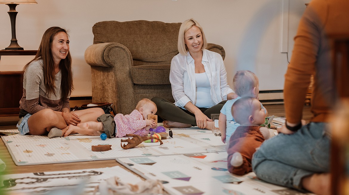 Group of parents and babies sitting on floor at Whitefish Together Group at Whitefish Community Center. Left to Right. Samara Marney, Annabelle Marney, Sara Mork, Jack Taylor, Sophia Saucier and Jennifer Saucier. (Kristen Fortier photo)